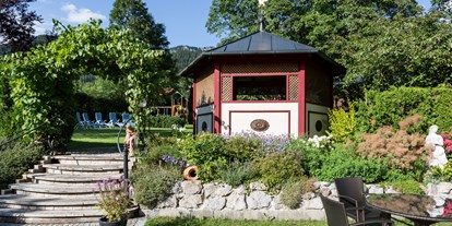 Mountainbike Urlaub - Preisniveau: günstig - Kitzbühel - Großer Garten mit Liegewiese und Kinderspielplatz direkt am Fuße des Wendelstein - Hotel Der Alpenhof